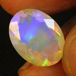 6.33CTS Natural Color Play White Opal 16.5X12.5X7.8MM Oval Faceted Gemstone--vdo. Fixed Price $129.99.